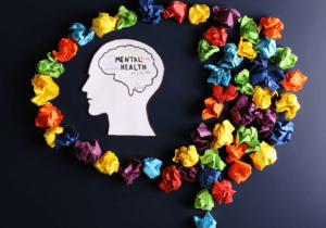 A head made of paper with the words mental health written on it.