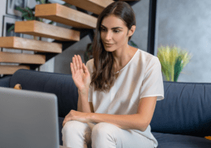 A woman sitting on the couch looking at her laptop