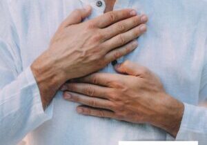 A man with his hands on his chest.
